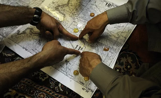 Hands pointing at a map