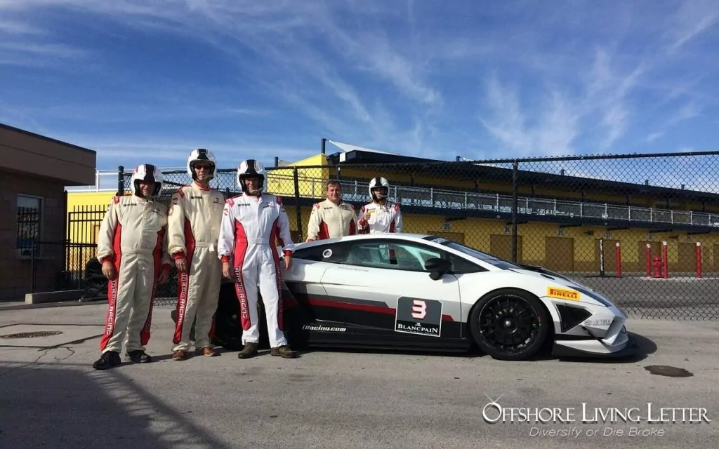 Lief Simon and friends standing next to a racecar in Las Vegas, Nevada before taking turns driving on the track.