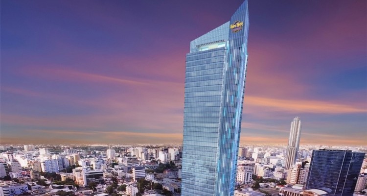Hard Rock International Hotel Being Built In Santo Domingo, DR. Hotel towers above the skyline. the sky is orange and purple at sunset