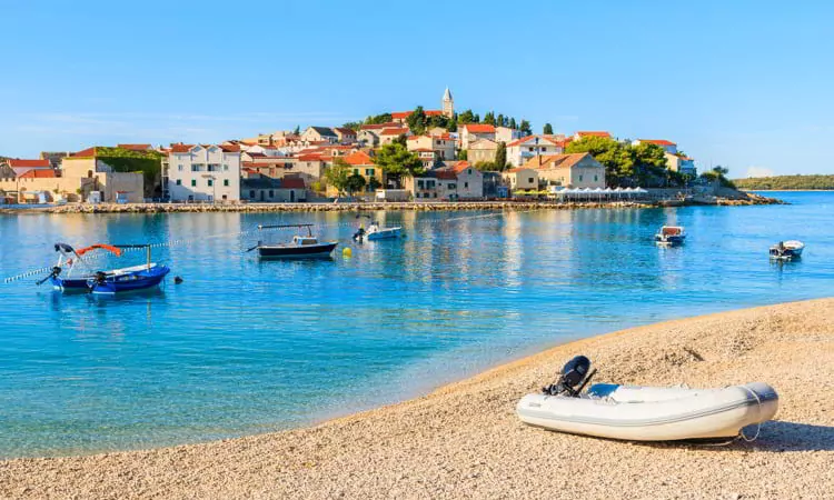 Dingy boat on idyllic beach in Primosten town, Dalmatia, Croatia