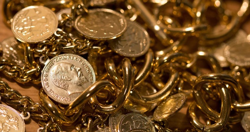 pile of gold coins and jewelry