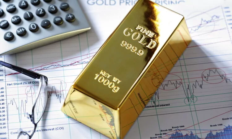 Gold bullion bar on a stocks and shares chart.