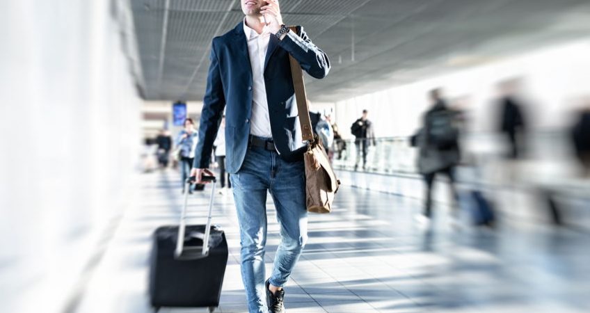 A businessman in a suit walking through an airport