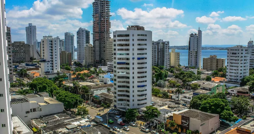 Back up residency in colombia. a high rise building in colombia with new developments being built in the background