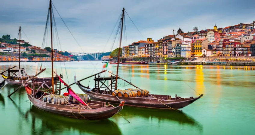 Sailboats with barrel cargo sitting in the harbour on the river in Lisbon, Portugal