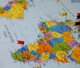 map with flags planted on different countries