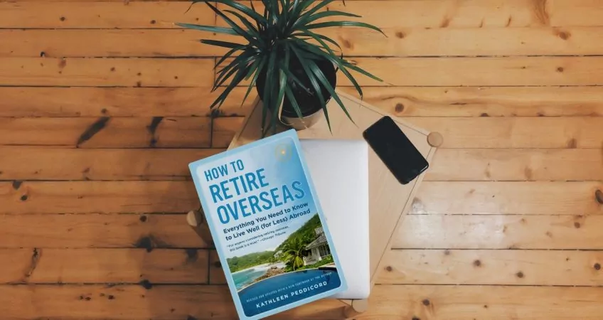 How To Retire Overseas book on a wooden floor