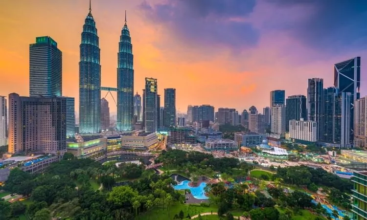 Kuala Lumpur, Malaysia skyline at dusk over the park.