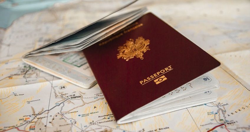 two passports laying on top of a map