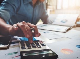 man calculating taxes with a calculator