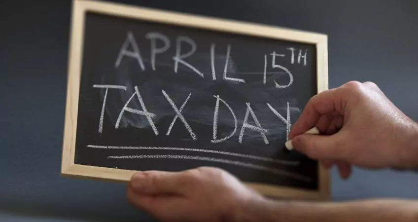 Blackboard with April 15 Tax Day written in big letters