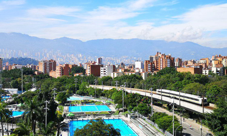 View of swimming pools and metro train, city of Medellín Colombia.