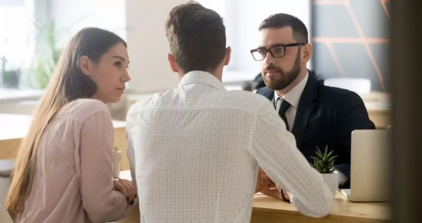 A couple meeting with their attorney