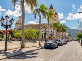 Caribbean old city street, church, independence square, tropical plants, palm tree, mountain view, Puerto Plata, Dominican Republic