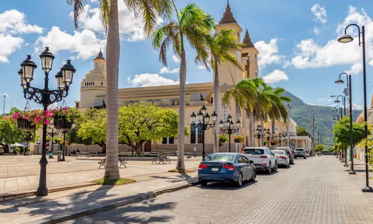 Caribbean old city street, church, independence square, tropical plants, palm tree, mountain view, Puerto Plata, Dominican Republic