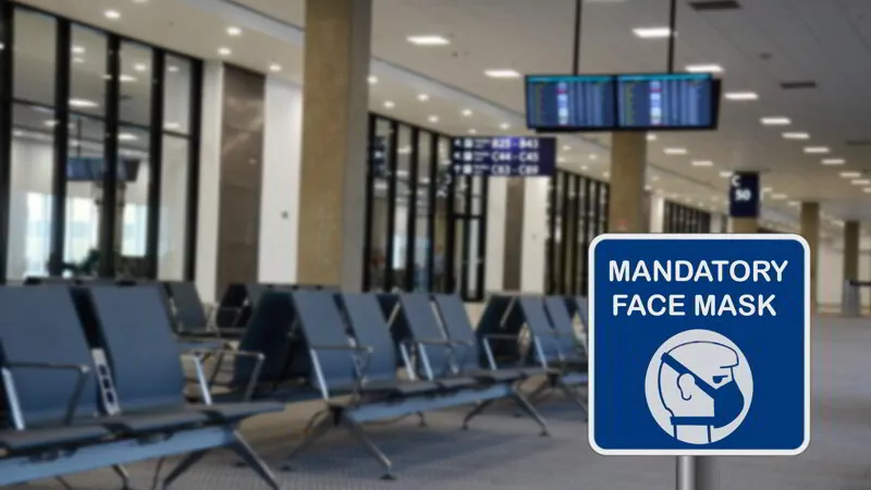 Blue sign warning of that face mask is mandatory due to Covid-19 or coronavirus in airport.