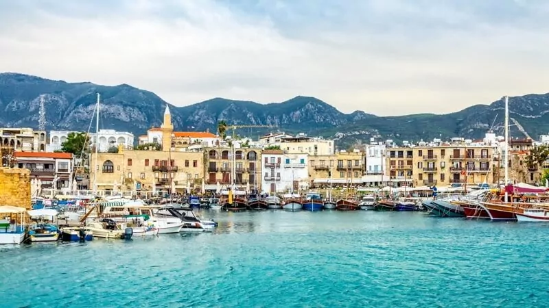 Kyrenia historical city center, view to marina with many yachts and boats and mountains in the background, North Cyprus