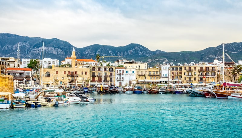 Kyrenia historical city center, view to marina with many yachts and boats and mountains in the background, North Cyprus