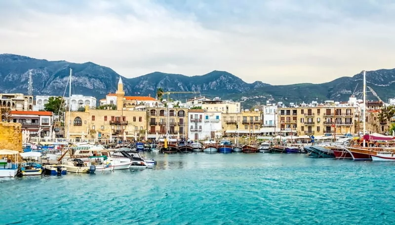 Kyrenia historical city center, view to marina with many yachts and boats and mountains in the background, North Cyprus