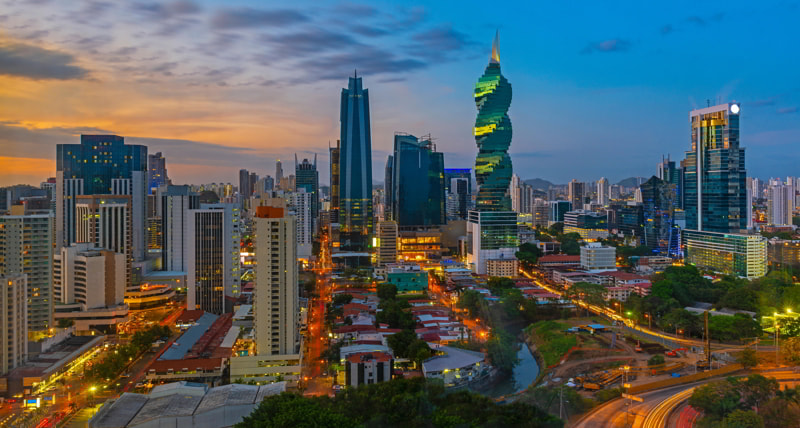 Colorful panorama of the skyline of Panama City at sunset with high rise skyscrapers, Panama.