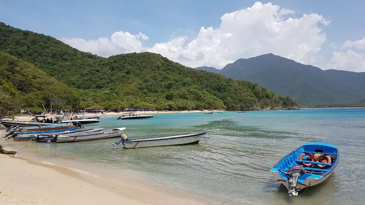 A beach with small fishing boats in Santa Marta, Colomia