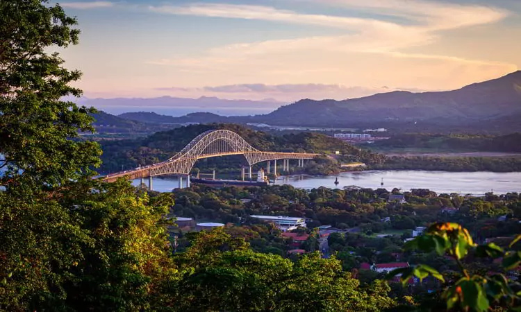 Container ship passing through Panama Canal in scenic landscape