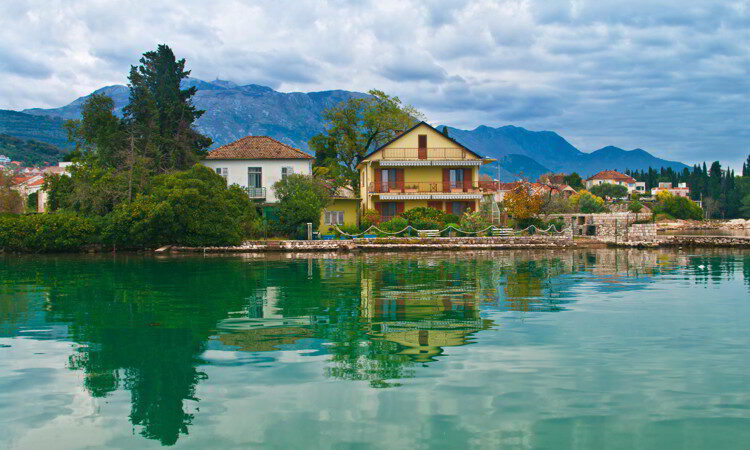 House by sea on cloudy day in Tivat, Montenegro.