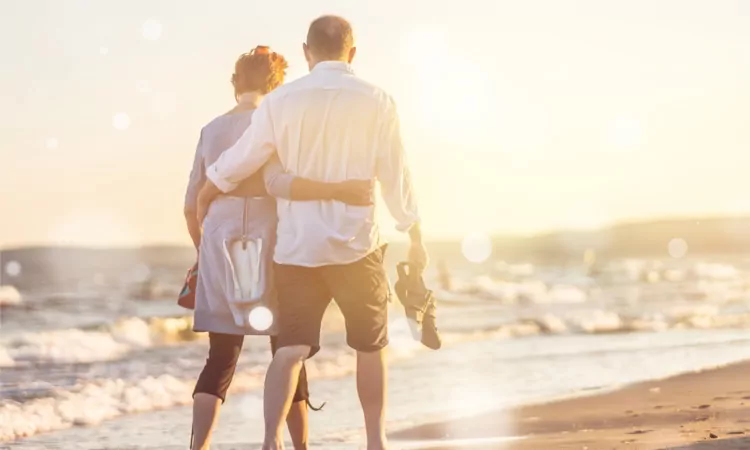 Close-up portrait of an elderly couple hugging on seacoast