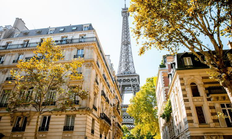 Beautiful street view with old residential buildings and Eiffel tower during the daylight in Paris