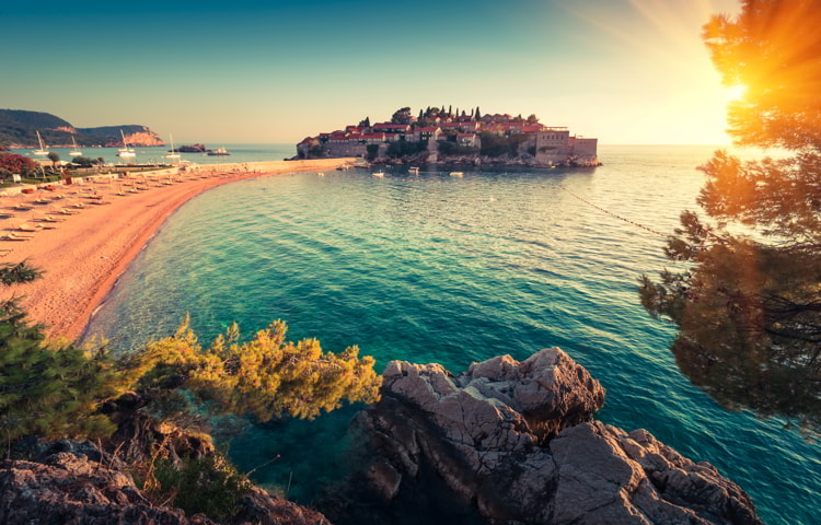 View in the Adriatic sea and Sveti Stefan at sunset