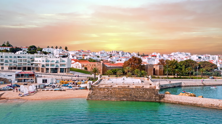 Aerial from the city Lagos with the Forte da Bandeira in Portugal at sunset