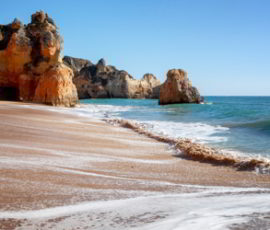 A panoramic view of a white sandy beach in Algarve, Portugal