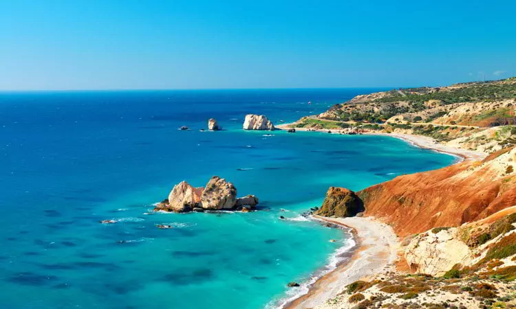 Seashore and pebble beach with wild coastline in Cyprus island, Greece by Petra tou Romiou sea rocks