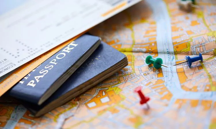 Pins marking travel itinerary points on map and passport