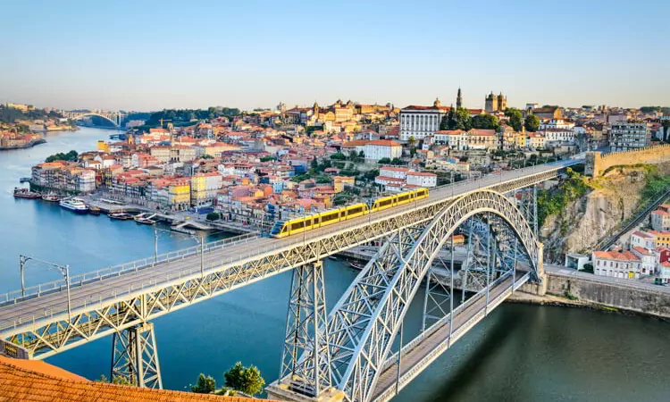 An image of a bridge and the city of Porto, Portugal during the day