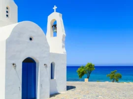 Blue skies and the view of a white church on a shore in Protaras, Cyprus