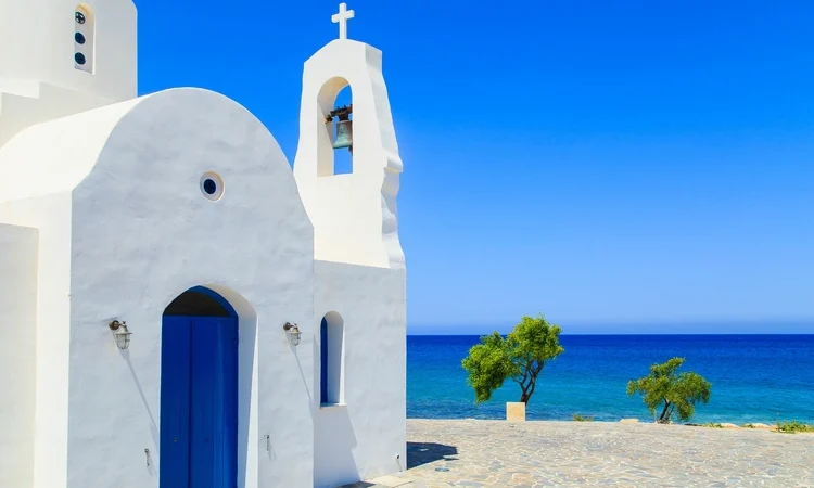 Blue skies and the view of a white church on a shore in Protaras, Cyprus