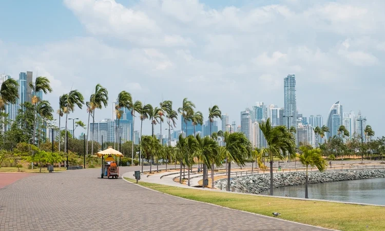 Sidewalk at public park with city skyline at coast promenade in Panama City Panama