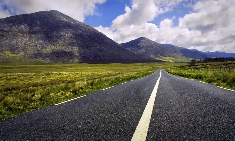 Landscape scenery of road by the lough inagh with mountains in the background at Connemara National park in county Galway, Ireland