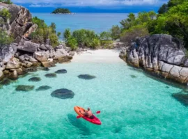 Aerial drone view of in kayak in crystal clear lagoon sea water during summer day near Koh Lipe island in Thailand. Travel tropical island holiday concept