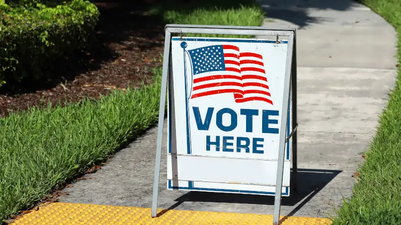 VOTE HERE SIGN placed on the walkway to a neighborhood polling place, as seen on election day in Fort Lauderdale, Florida, USA.