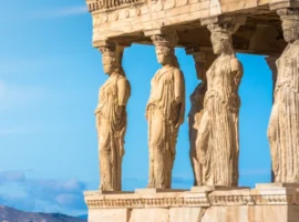 The iconic Caryatid Porch of the Erechtheion on the Acropolis in Athens, Greece, representing the timeless heritage and appeal of living in the birthplace of democracy.